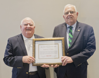 Lawrence J. Baker (left) receives the CNY RPDB's Rhea Eckel Clark Citizenship Award from Board Chairman James J. Murphy, Jr., at the Board's 2018 Annual Meeting