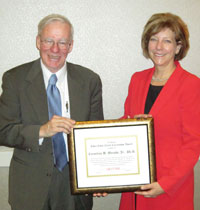 Cornelius B. Murphy, Jr., Ph.D. (left) receives the CNY RPDB's Rhea Eckel Clark Citizenship Award from Board Chairwoman Kathleen A. Rapp at the Board's 2013 Annual Meeting