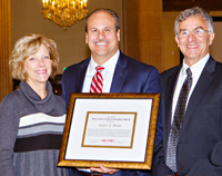 Robert Daino (center) receives the CNY RPDB's Rhea Eckel Clark Citizenship Award from Board Chairwoman Kathleen A. Rapp and Executive Director David V. Bottar at the Board's 2016 Annual Meeting