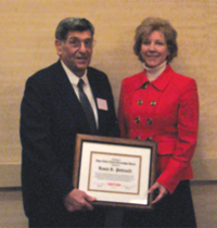 Louis Pettinelli (left) receives the CNY RPDB's Rhea Eckel Clark Citizenship Award from Board Chairwoman Kathleen A. Rapp at the Board's 2010 Annual Meeting