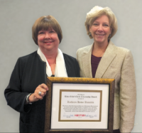 Katheryn Howe Ruscitto (left) receives the CNY RPDB's Rhea Eckel Clark Citizenship Award from Board Chairwoman Kathleen A. Rapp at the Board's 2015 Annual Meeting